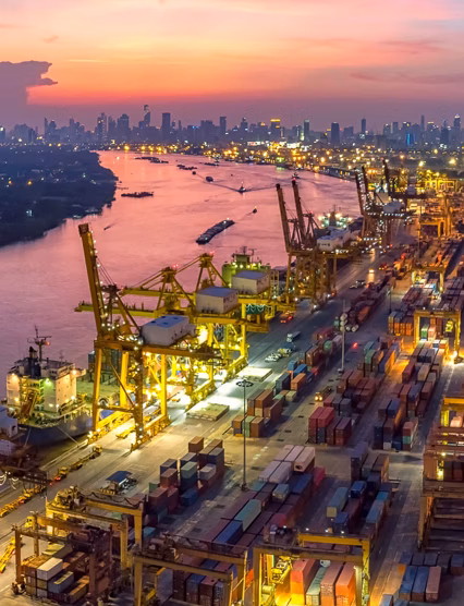 Logistics and transportation of Container Cargo ship and Cargo plane with working crane bridge in shipyard at sunrise, logistic import export and transport industry background