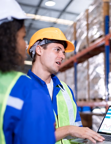 Diversity of Warehouse staff wearing a protective face mask in safety suite using apps on digital tablet checking and receiving items goods for storage in the warehouse, modern smart logistic industry