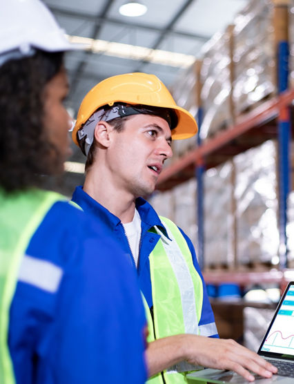 Diversity of Warehouse staff wearing a protective face mask in safety suite using apps on digital tablet checking and receiving items goods for storage in the warehouse, modern smart logistic industry