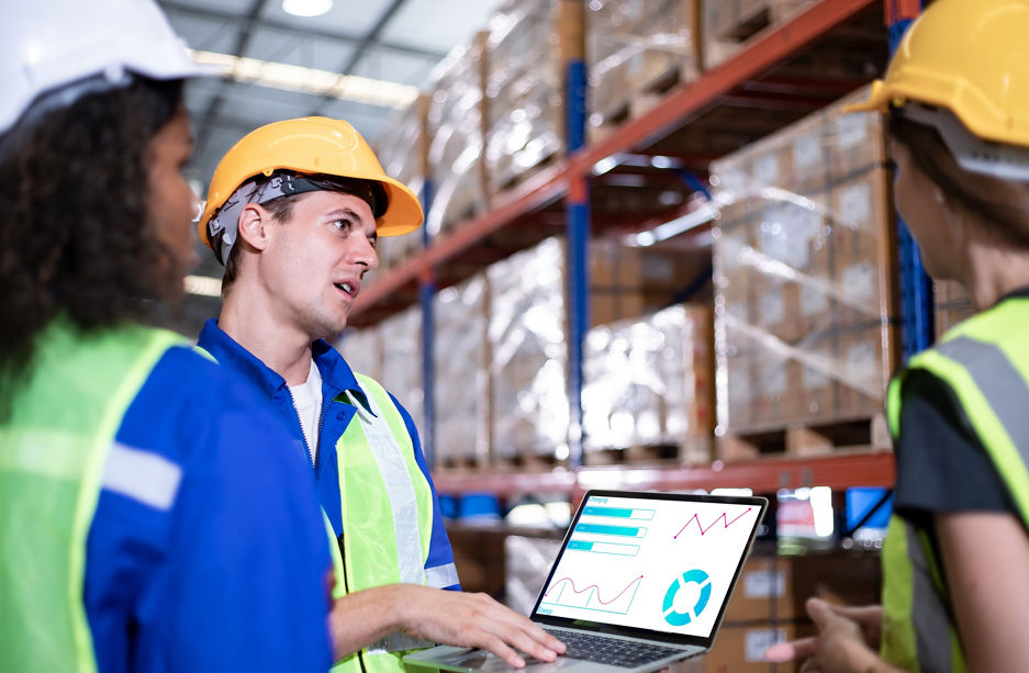 Diversity of Warehouse staff wearing a protective face mask in safety suite using apps on digital tablet checking and receiving items goods for storage in the warehouse, modern smart logistic industry