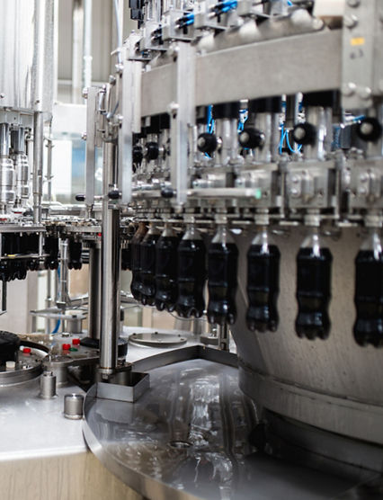 Water bottling line for processing and bottling black carbonated juice into bottles.