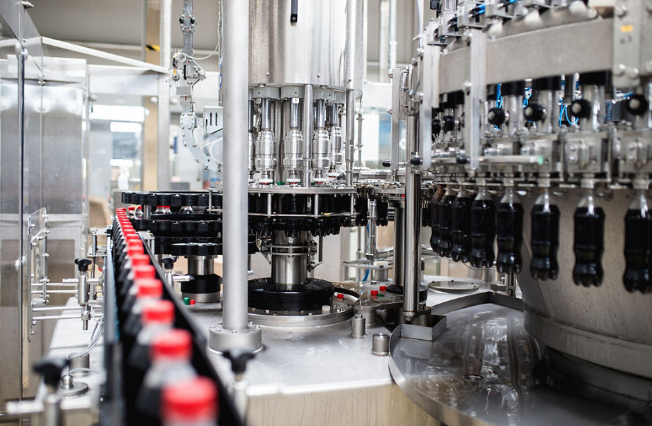 Water bottling line for processing and bottling black carbonated juice into bottles.