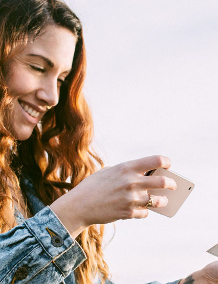 woman smiling at her phone