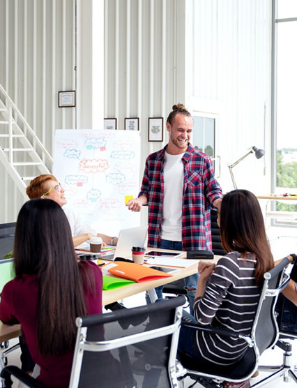 Group of young attractive asian creative design team meeting,smiling and laughing at office workshop. Asian employee engaged together with effective and productive meeting and happy workplace concept.