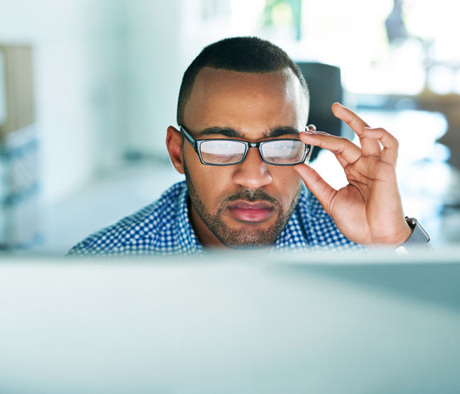 Cropped shot of a handsome young businessman working in his office