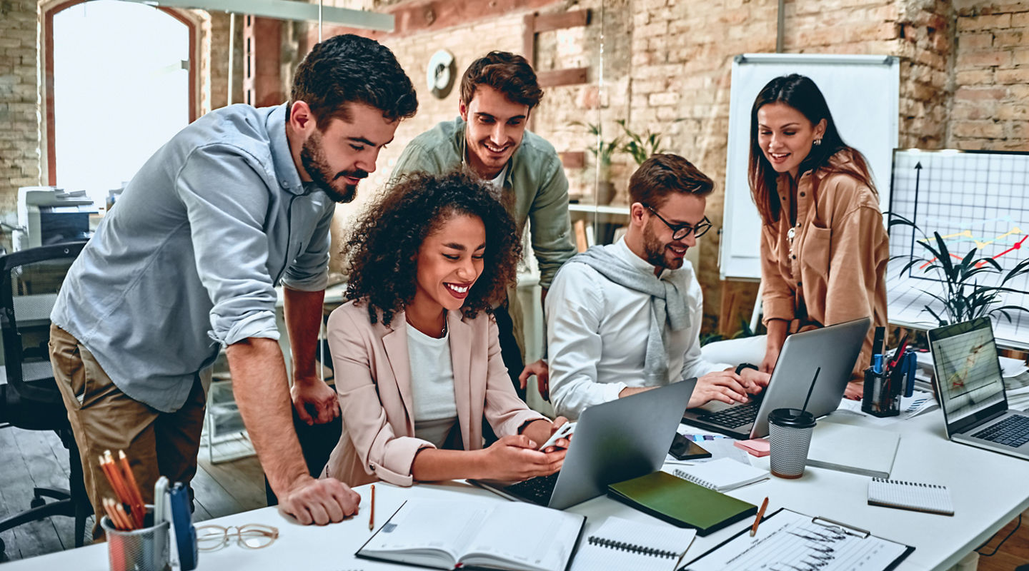 Group of young multiracial business people are working in modern office. Freelancers in coworking place. Creative and stylish youth.