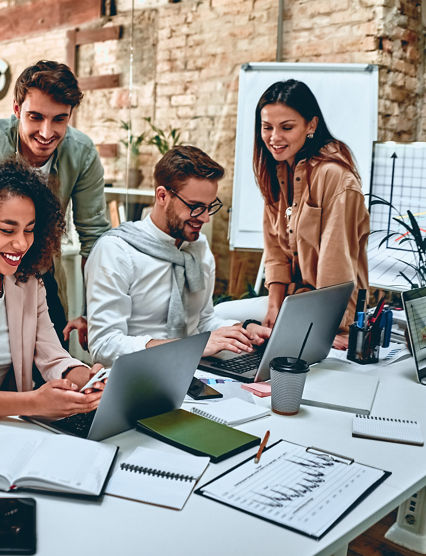 Group of young multiracial business people are working in modern office. Freelancers in coworking place. Creative and stylish youth.
