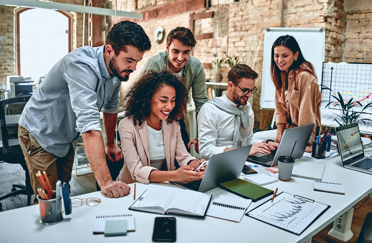 Group of young multiracial business people are working in modern office. Freelancers in coworking place. Creative and stylish youth.