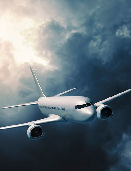 Mid-sized passanger airplane flying in stormy clouds.