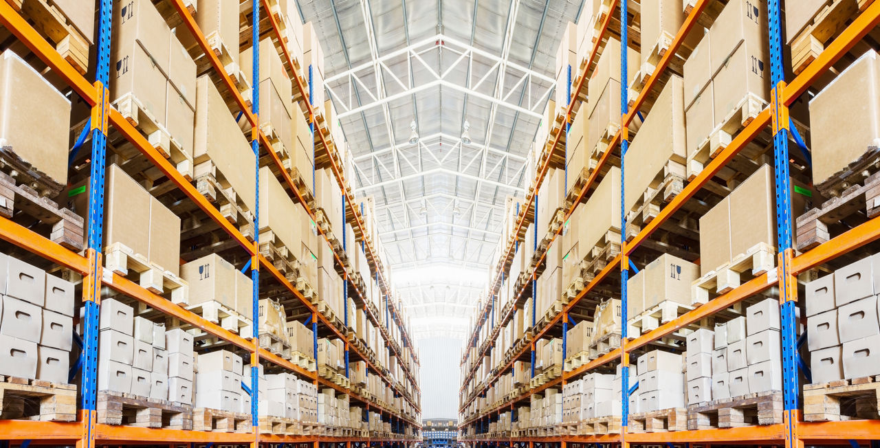 Rows of shelves with boxes in modern warehouse