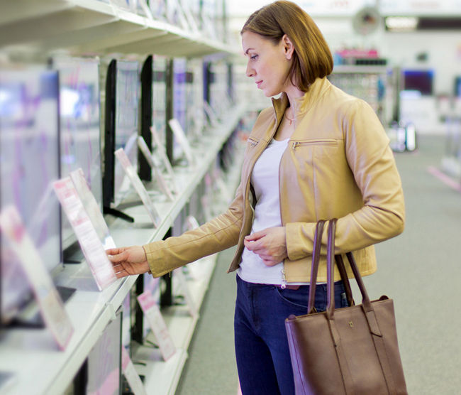 woman looking at electronics.