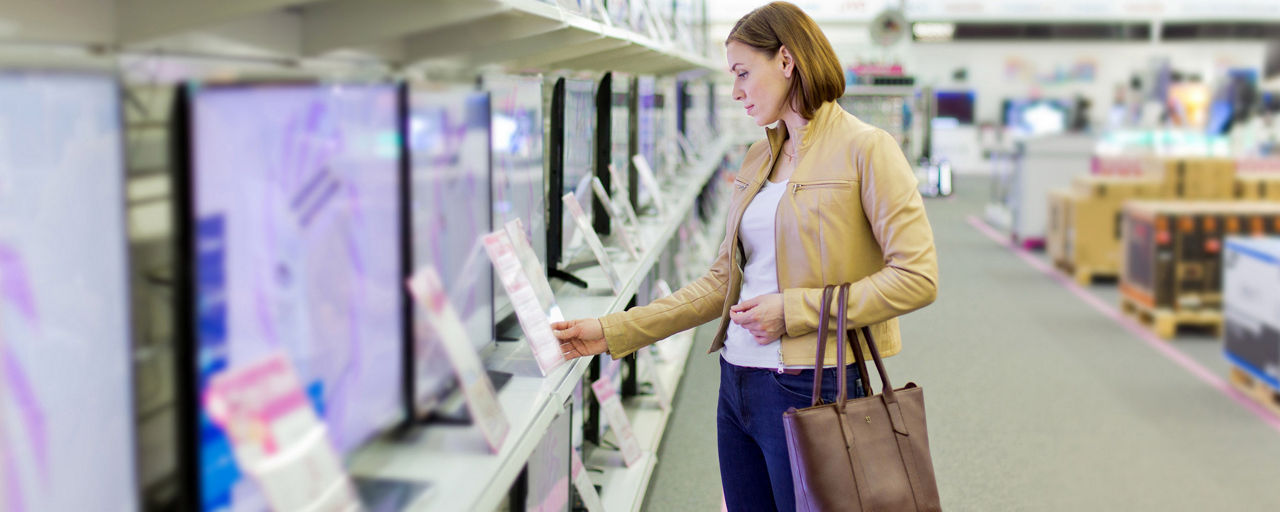 woman looking at tvs