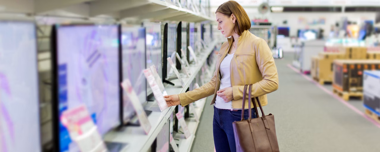 woman looking at tvs