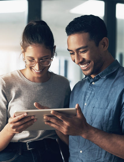 Shot of two young workers using a digital tablet in a modern office.