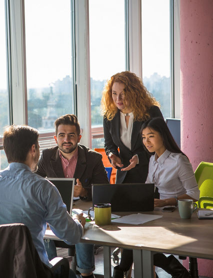 Business people listening to one of their colleague bad or good news for their company, enterprise or firm while working round table in board room in office.