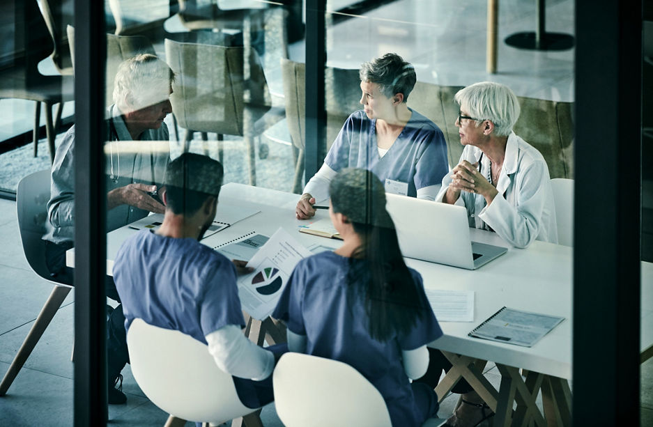 Shot of a group of medical professionals having a meeting together inside a boardroom at a hospital