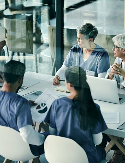 Shot of a group of medical professionals having a meeting together inside a boardroom at a hospital