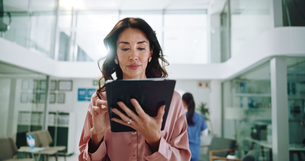 Hospital, consultant and woman on tablet for medical service, results and internet research. Healthcare, clinic and person on digital tech for online administration, planning and insurance on website.