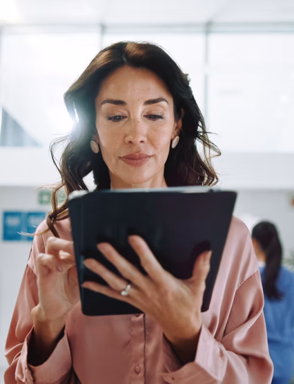 Hospital, consultant and woman on tablet for medical service, results and internet research. Healthcare, clinic and person on digital tech for online administration, planning and insurance on website.