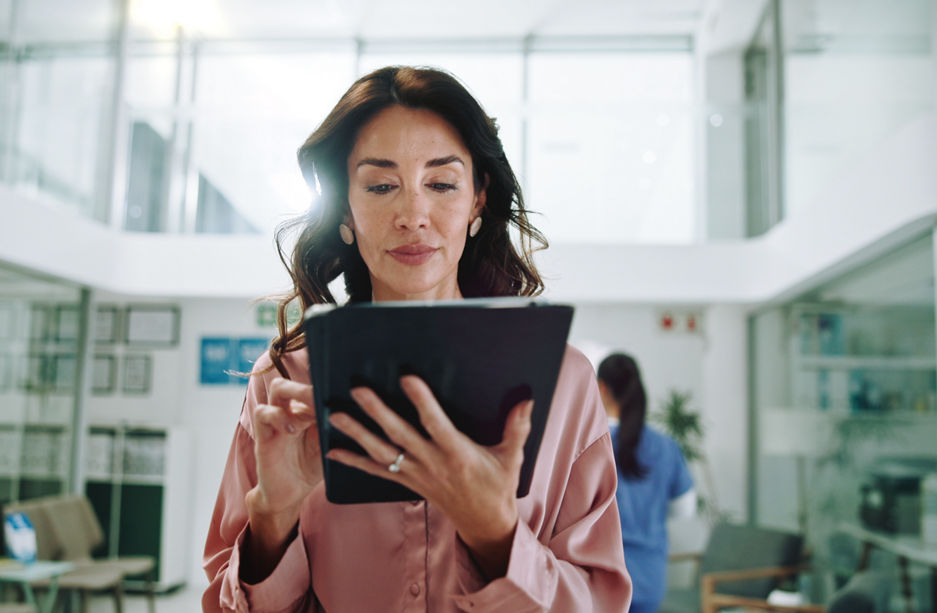 Hospital, consultant and woman on tablet for medical service, results and internet research. Healthcare, clinic and person on digital tech for online administration, planning and insurance on website.