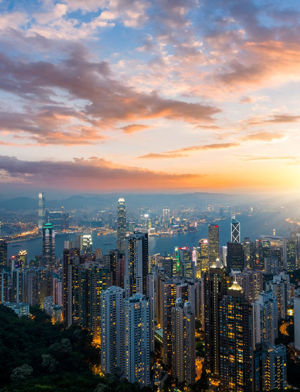 skyscraper on two side of Victoria Harbour of Hong Kong. View from the Peak at night.