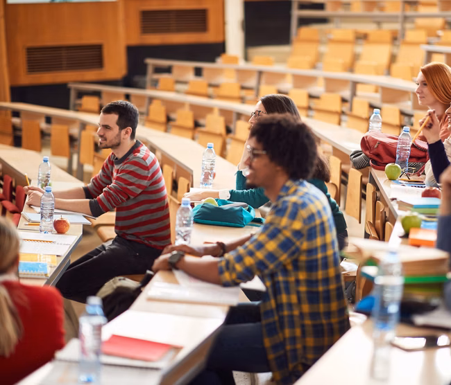 Young students focused on lecture in amphitheater