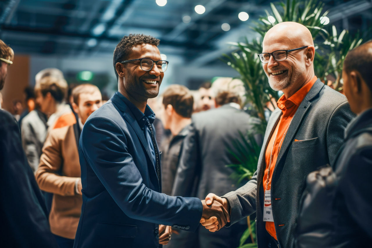 Strong handshake exchanged at a professional networking event or a conference.