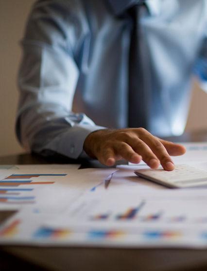 Business accounting concept, Business man using calculator with computer laptop, budget and loan paper in office.