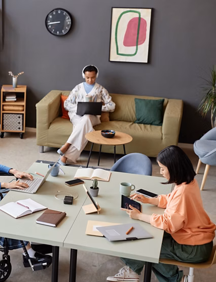 High angle view at modern office with diverse young people working at separate tasks, copy space