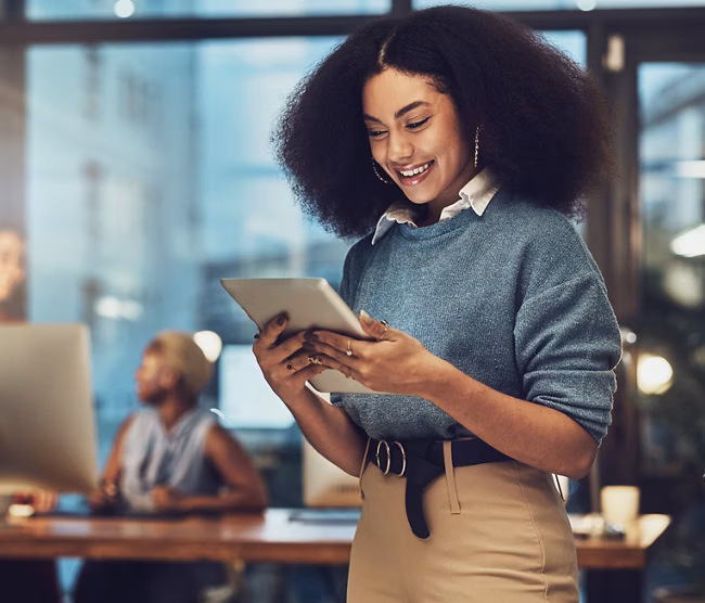 Business, tablet and night with woman in office for technology, happy and communication. Social media, connection and internet with female and search online for networking, email and website.