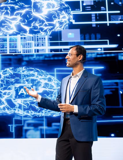 Cheerful presenter speaking at tech conference, exploring latest AI technology trends and case studies. Upbeat IT professional presenting how artificial intelligence is shaping future during event