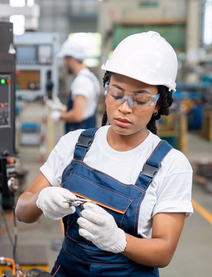 Female Engineer Programming A CNC Machine At Factory