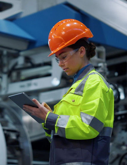 Female electrician examining machine