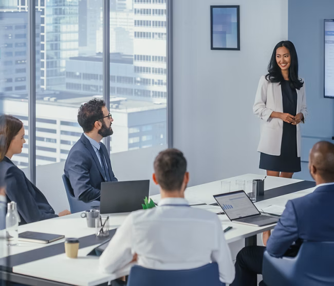 Diverse Office Conference Room Meeting: Asian Female Project Manager Presents Digital Business Expansion Strategy for Investment Team, Uses Wall TV with Big Data Analysis, e-Commerce Infographics.