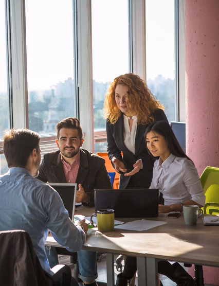 Business people listening to one of their colleague bad or good news for their company, enterprise or firm while working round table in board room in office.