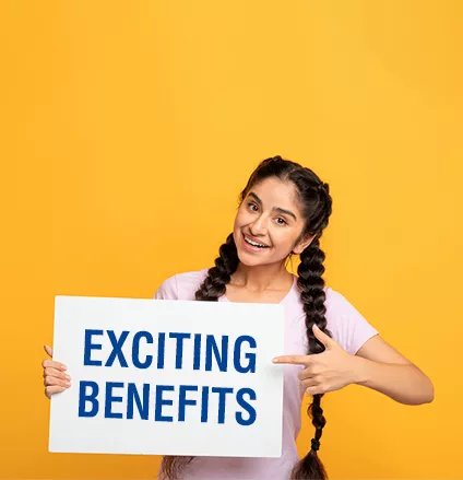 Place For Your Ad. Portrait of smiling indian lady holding empty blank board isolated on orange studio background. Happy woman standing with white square paper for template and pointing at it