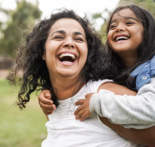 Happy indian mother having fun with her daughter outdoor - Family and love concept - Focus on mum face
