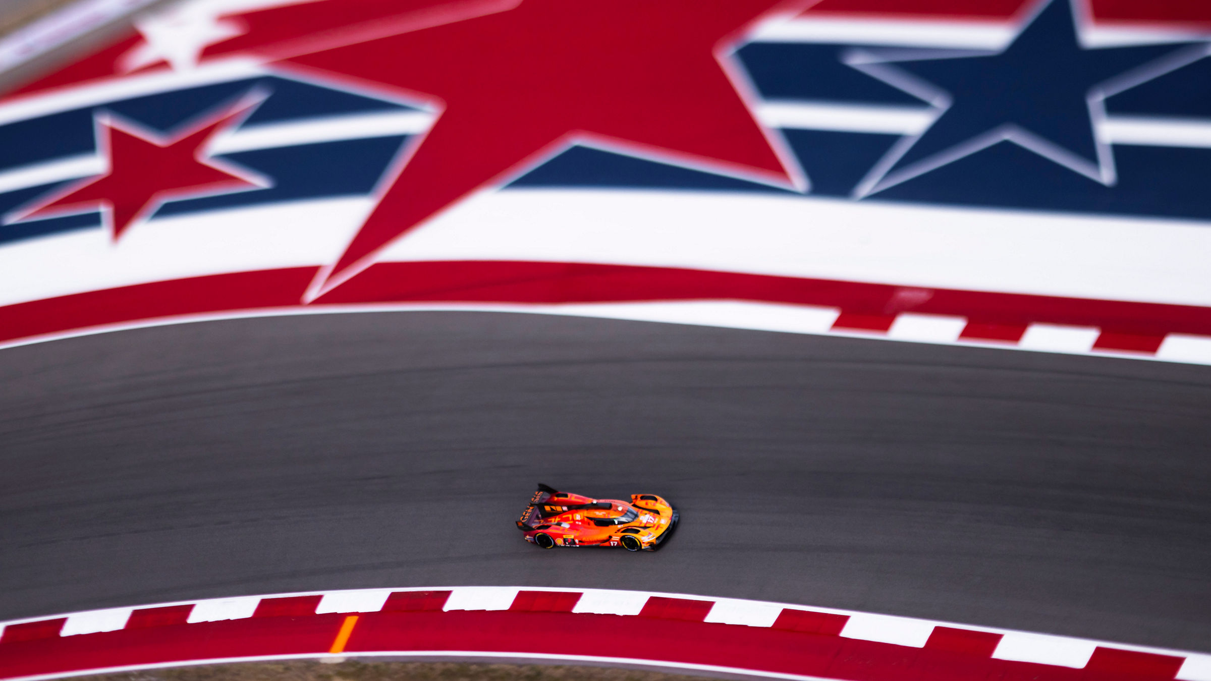 Genesis GMR-001 passes beneath COTA's iconic star-themed track design during Lone Star Le Mans.