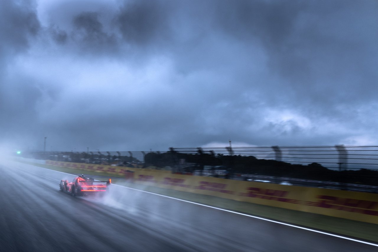 GMR-001 Hypercar racing through heavy rain and spray at WEC Fuji.