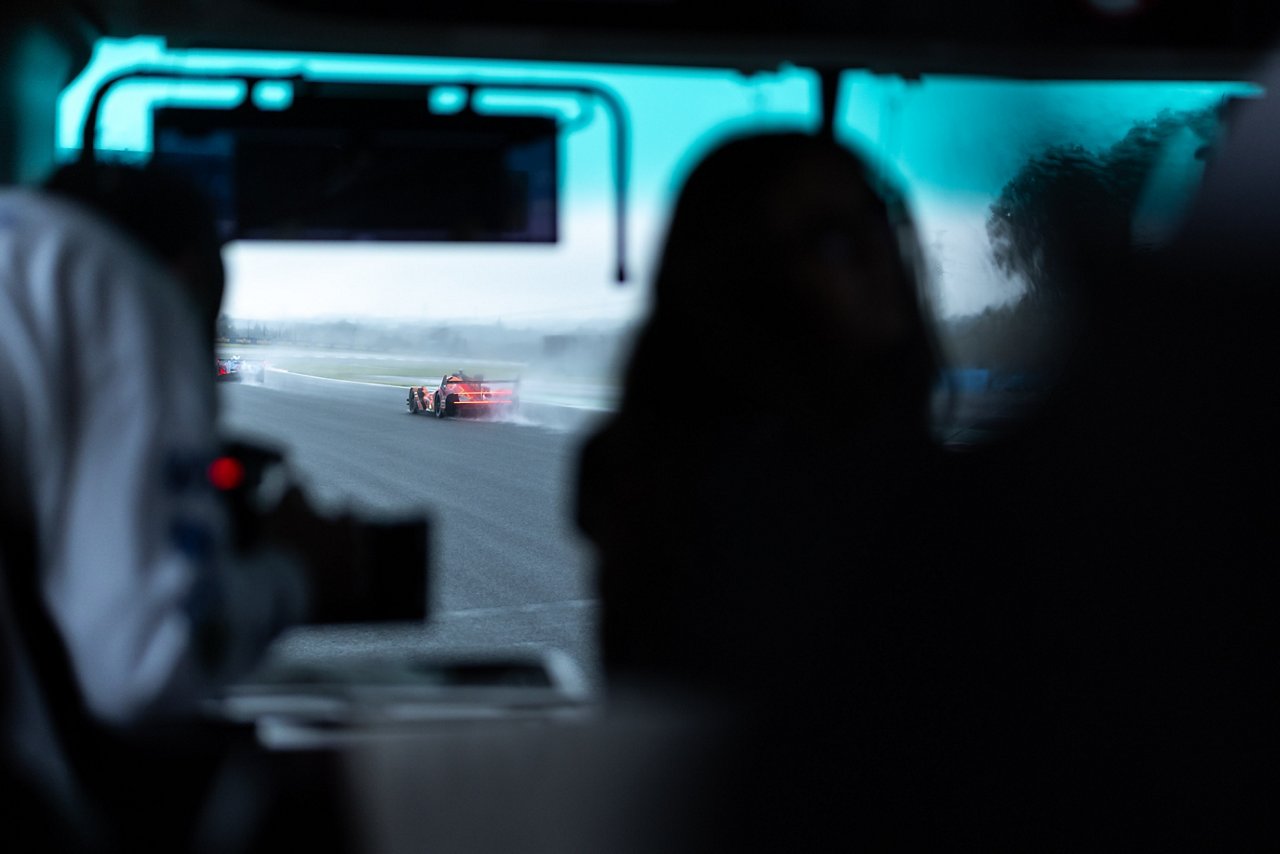 GMR-001 Hypercar racing in heavy rain at WEC Fuji, viewed from the garage.