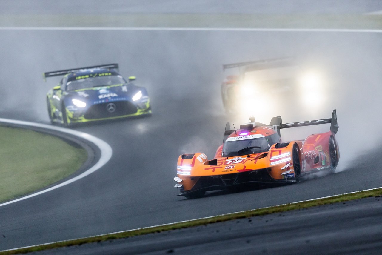GMR-001 Hypercar leading other race cars through heavy spray at WEC Fuji.