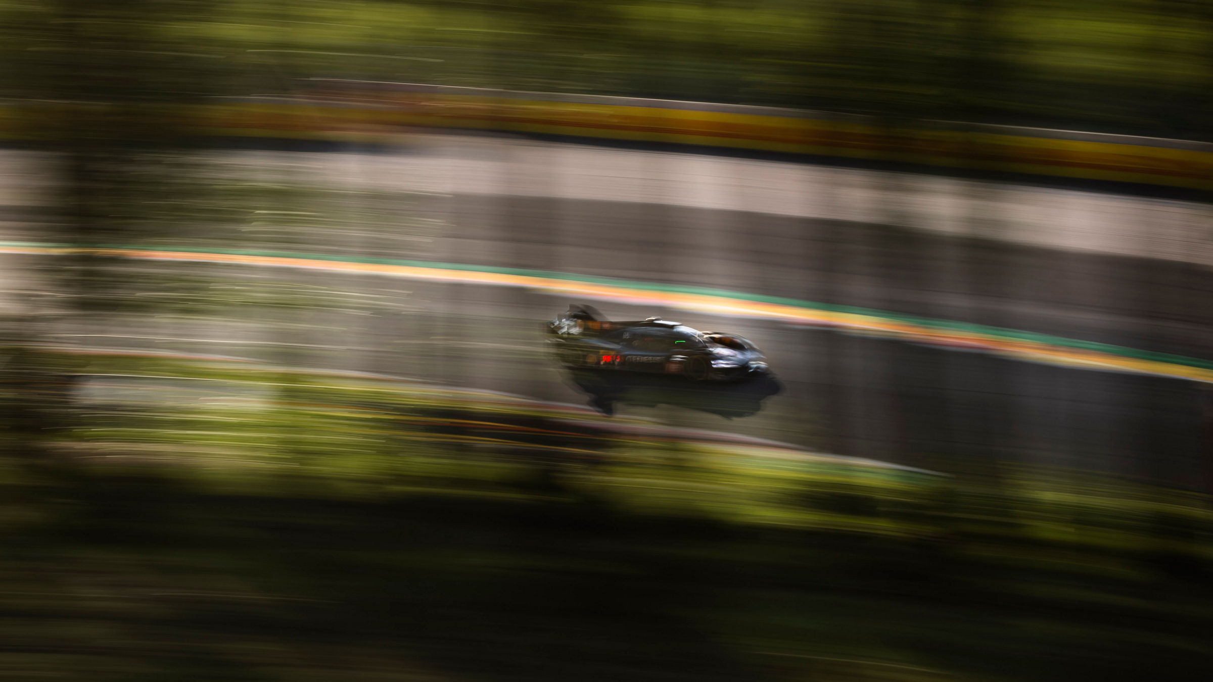 GRM-001 speeds through a corner at Spa‑Francorchamps.