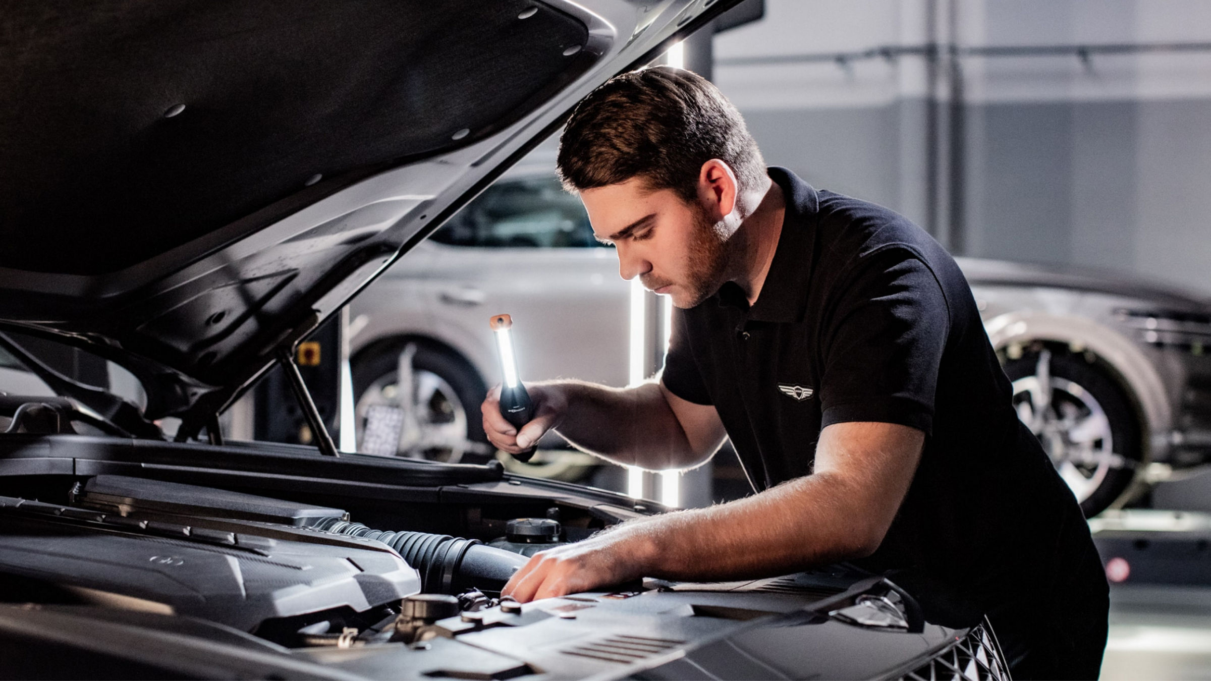 Mechanic working on the engine of a car