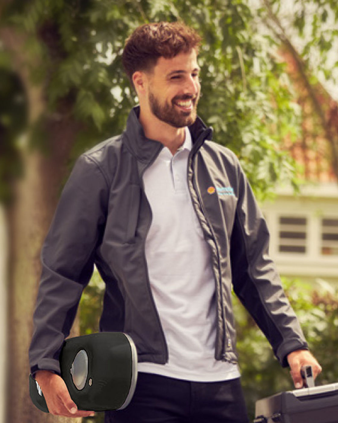 Man with beard and blouson delivers charger