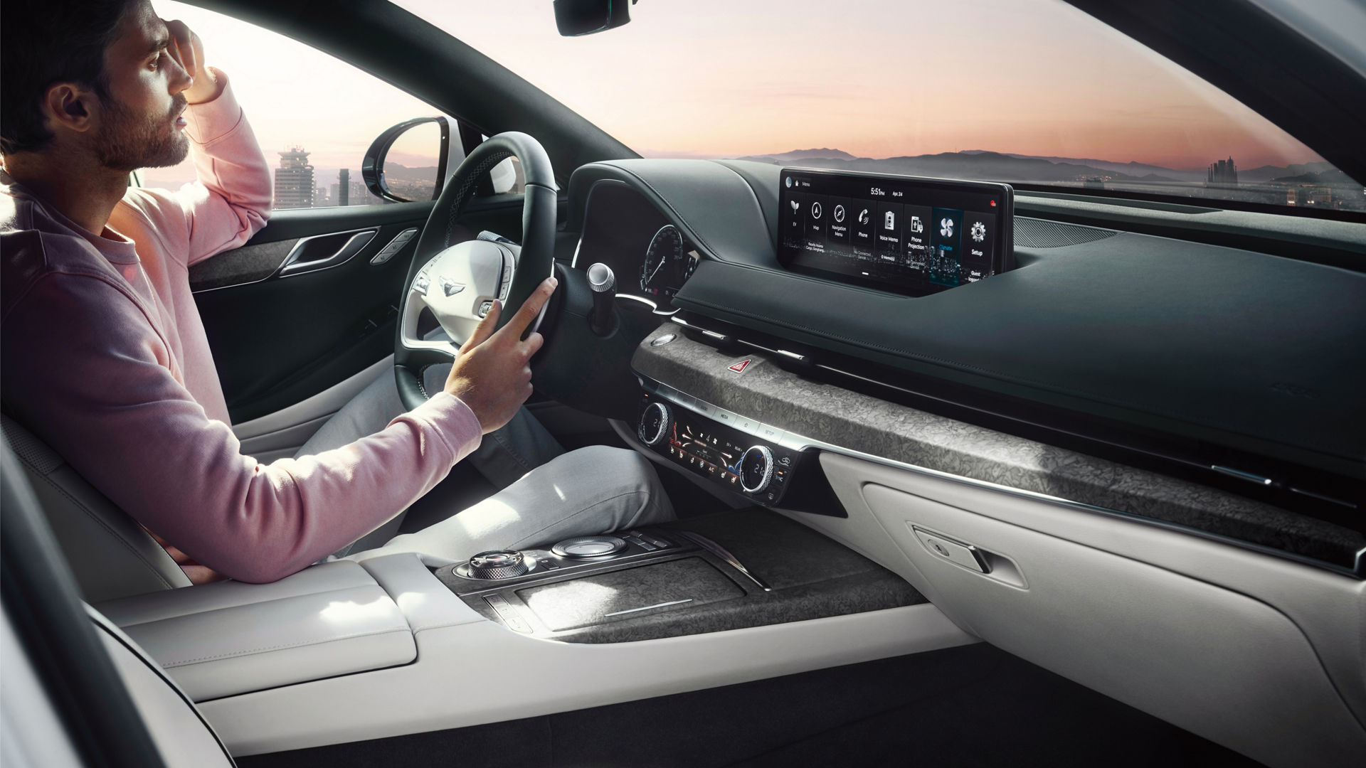 Man at the wheel of the Genesis G80 with beige interior