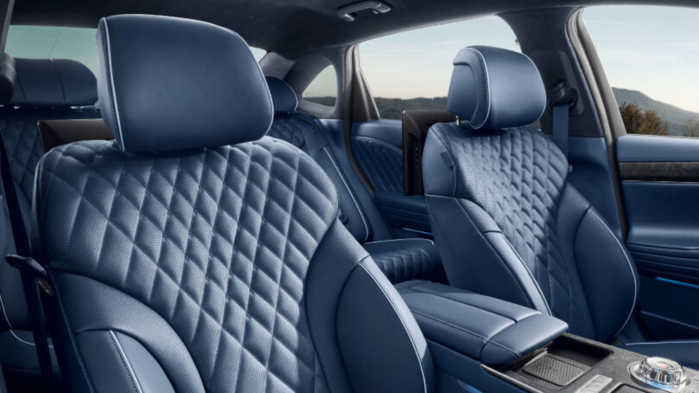 Side view of front and back seats with the armrest in the center.