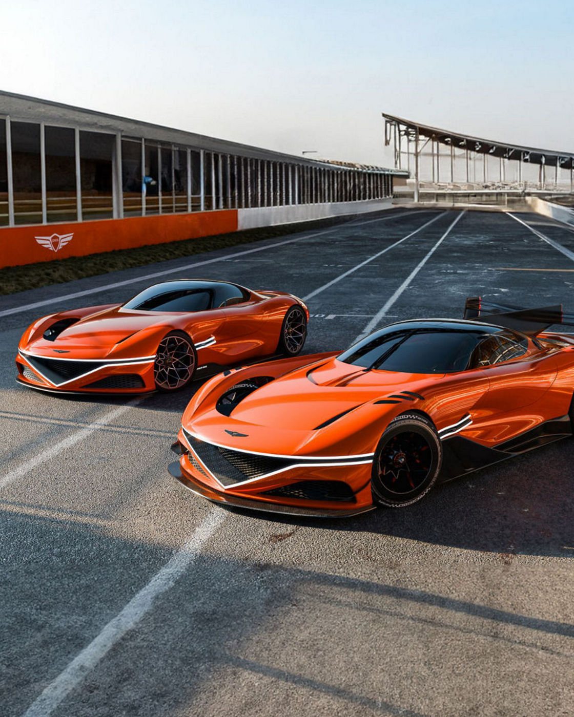 Two orange Genesis Magma Concepts on a racetrack