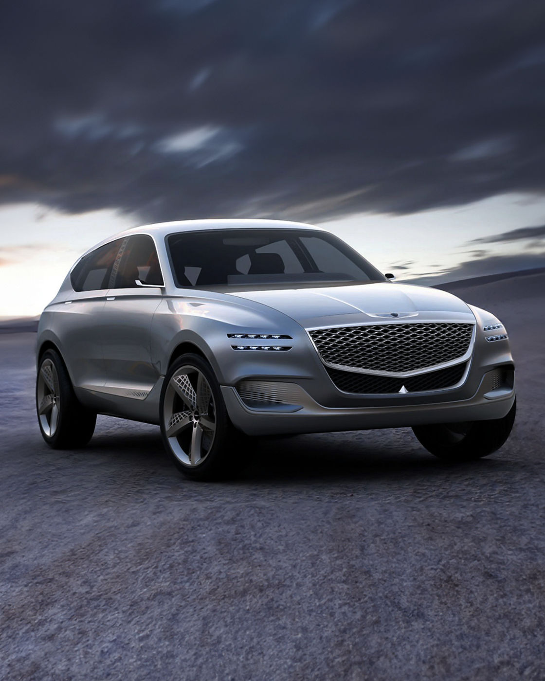 Genesis GV80 Concept car in silver, front view with a dramatic sky