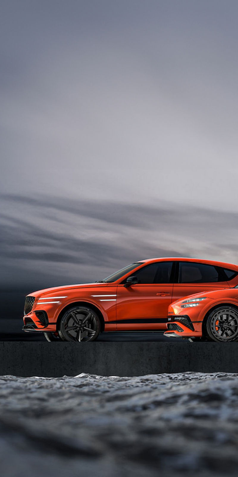 Two orange Genesis Magma Concept cars side by side - side view outdoors