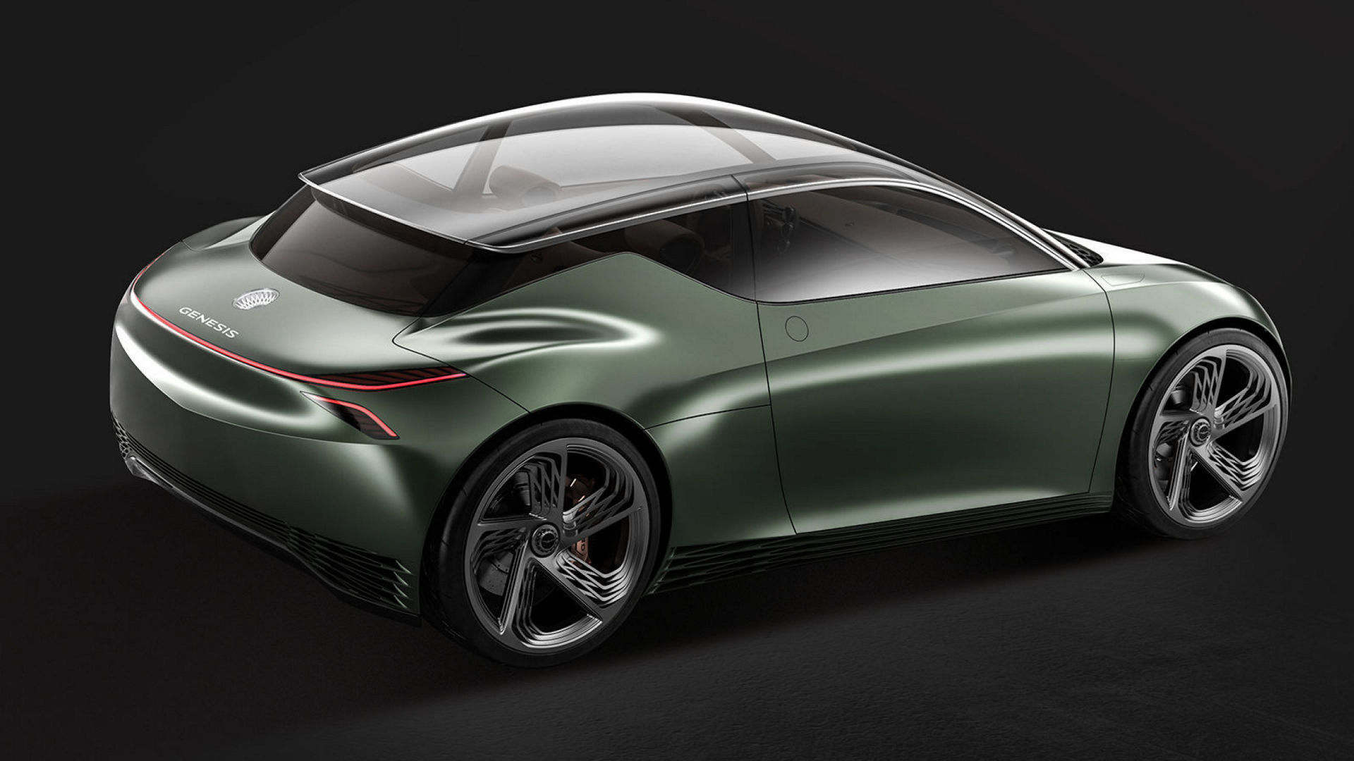 Rear-side view of the Genesis Mint Concept car in metallic green with a sleek glass roof.